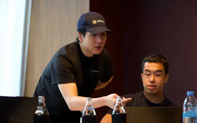 A mentor helping a founder at his laptop