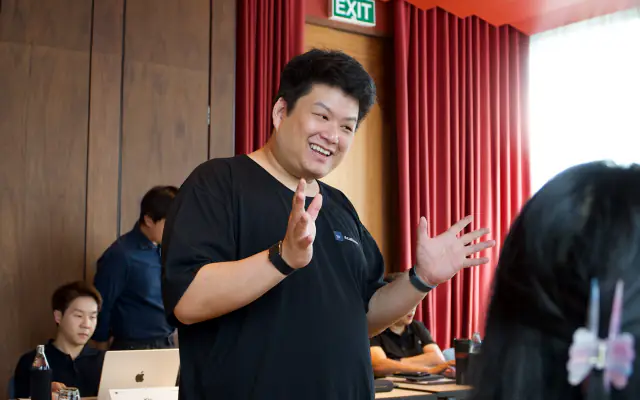 A mentor explaining an idea to the room of business owners
