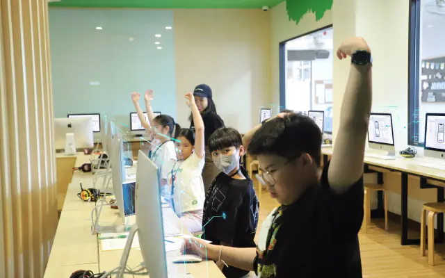Students cheering at their computers in the Lertlah School lab